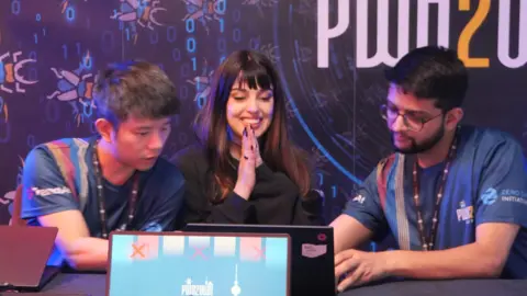 Pwn2Own Berlin Valentina 'Chompie' Palmiotti looking happy and tired as she wins prize