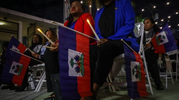 Above, people attend a candlelight vigil for Haitians living in the U.S. with Temporary Protected Status in Miami, Florida on February 3. Florida's economy could take a hit from the loss of TPS for Haitian workers.