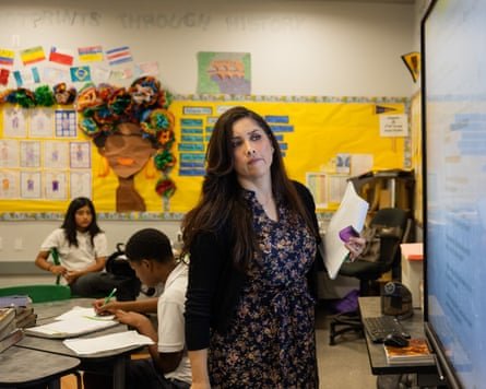A teacher in a classroom full of students.
