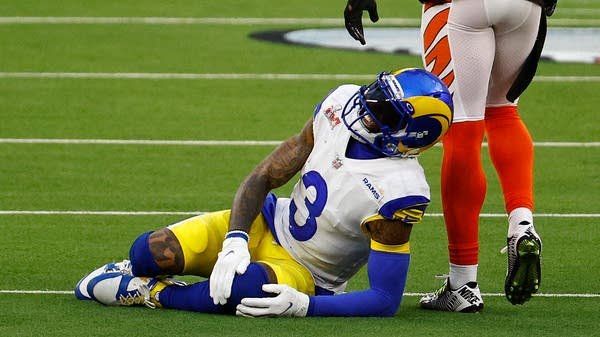 Los Angeles Rams receiver Odell Beckham Jr. lies on the turf at SoFi Stadium after a noncontact injury during Super Bowl LVI in 2022. The NFL Players Association claims that players get injured at a higher rate on turf fields.