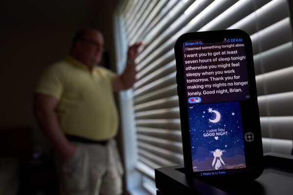 A text message from a scammer who stole $575,000 from Brian Glick is displayed on Glick's phone as he poses for a portrait at his home, Wednesday, June 25, 2025, in Ballston Lake, N.Y. (AP Photo/David Goldman)