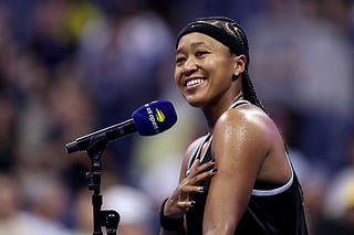Naomi Osaka of Japan reacts while being interviewed on court after defeating Anastasia Zakharova in their Women's Singles First Round match.